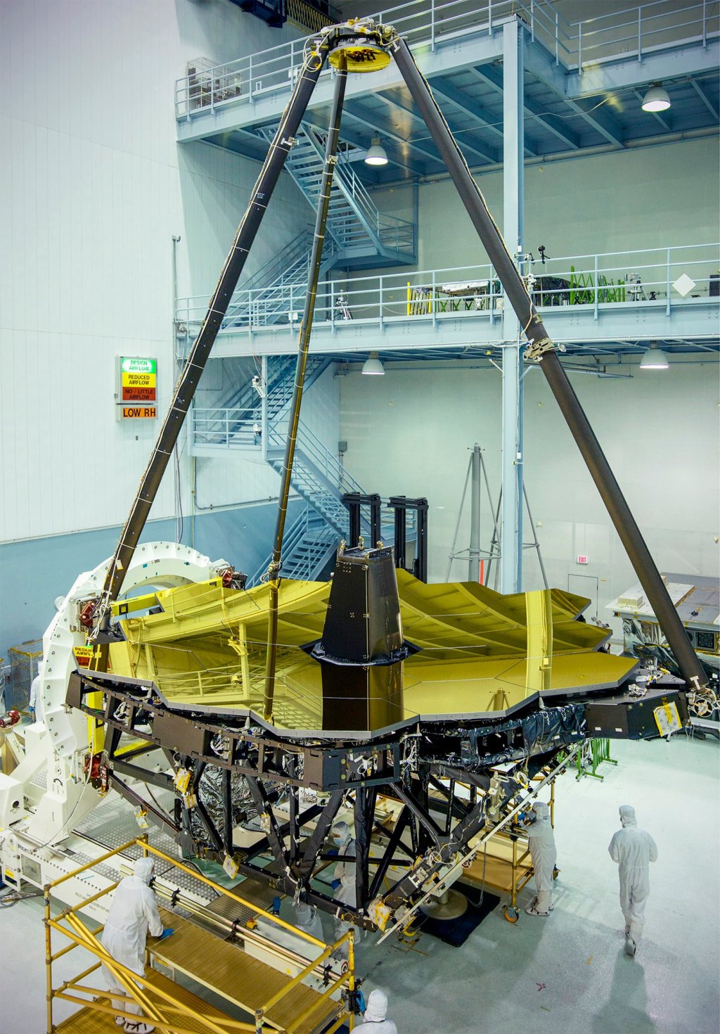 The James Webb Space Telescope’s gold-coated hexagonal primary mirror in a cleanroom.
